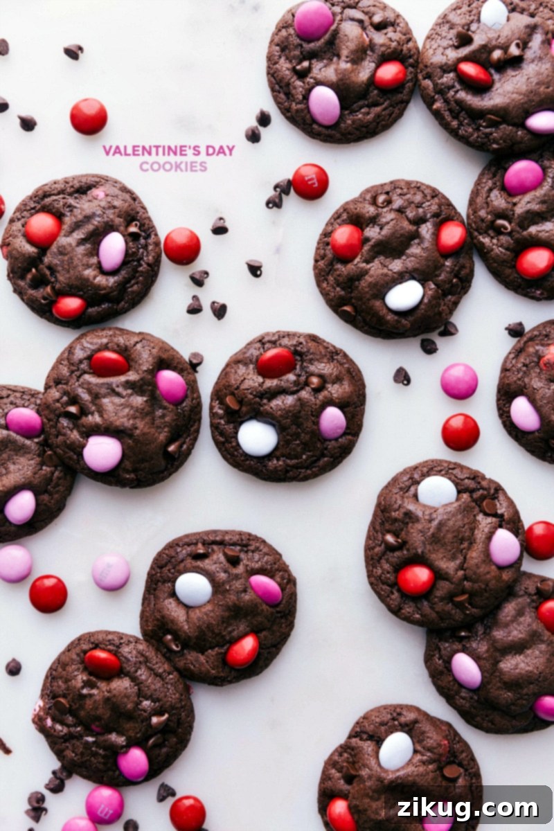 Baked Valentine cookies, ready to be enjoyed, with festive M&M's and chocolate chips.