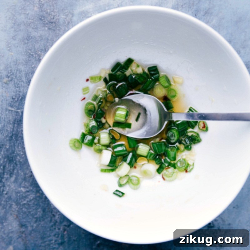 Zesty Green Onion Vinaigrette for Vegetarian Lettuce Wraps Small bowl filled with the savory green onion vinaigrette, ready to be drizzled.