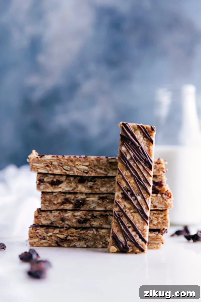 Arrangement of Tasty No-Bake Granola Bars Stack of delicious no-bake granola bars perfectly cut, with one laid on its side to show texture, and a beautiful chocolate drizzle.