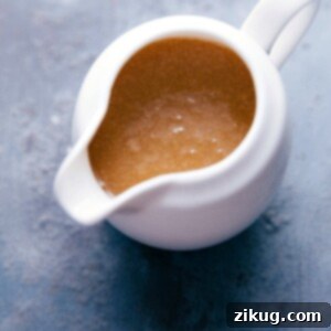 Container filled with creamy buttermilk syrup, with a silky texture, ready to be poured.