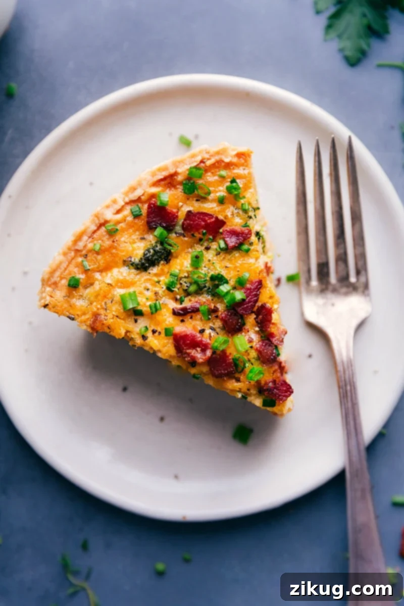 Broccoli Cheddar Quiche loaded with tender broccoli, sharp Cheddar cheese, and creamy egg custard. Easy to adapt and made simple with a store-bought pie crust! Perfect for breakfast, lunch, dinner, or brunch. Recipe via ChelseasMessyApron. Overhead image of a beautifully baked slice of Broccoli Cheddar Quiche, showcasing the tender broccoli, melted sharp Cheddar, and creamy egg custard, with a golden-brown crust.
