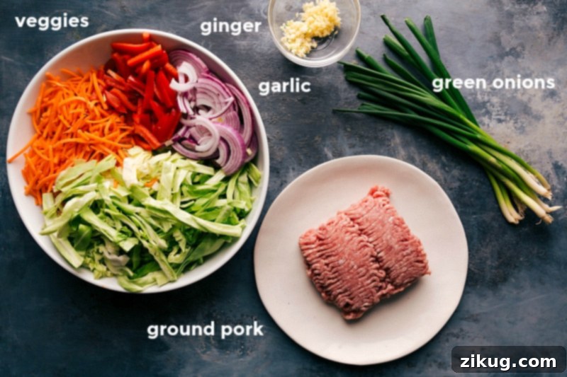 Key Ingredients for Preparing Egg Roll in a Bowl Recipe A vibrant collection of fresh ingredients for the Egg Roll in a Bowl recipe, including ground meat, various vegetables, and essential seasonings.