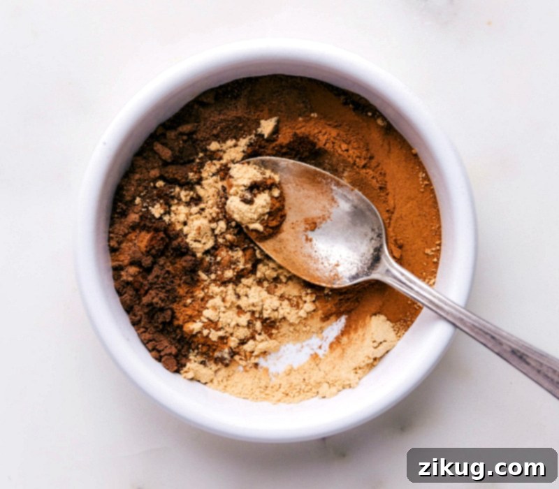 Crafting Homemade Pumpkin Pie Spice by Blending Ingredients A close-up of spices being mixed in a bowl, illustrating the process of making homemade pumpkin pie spice.