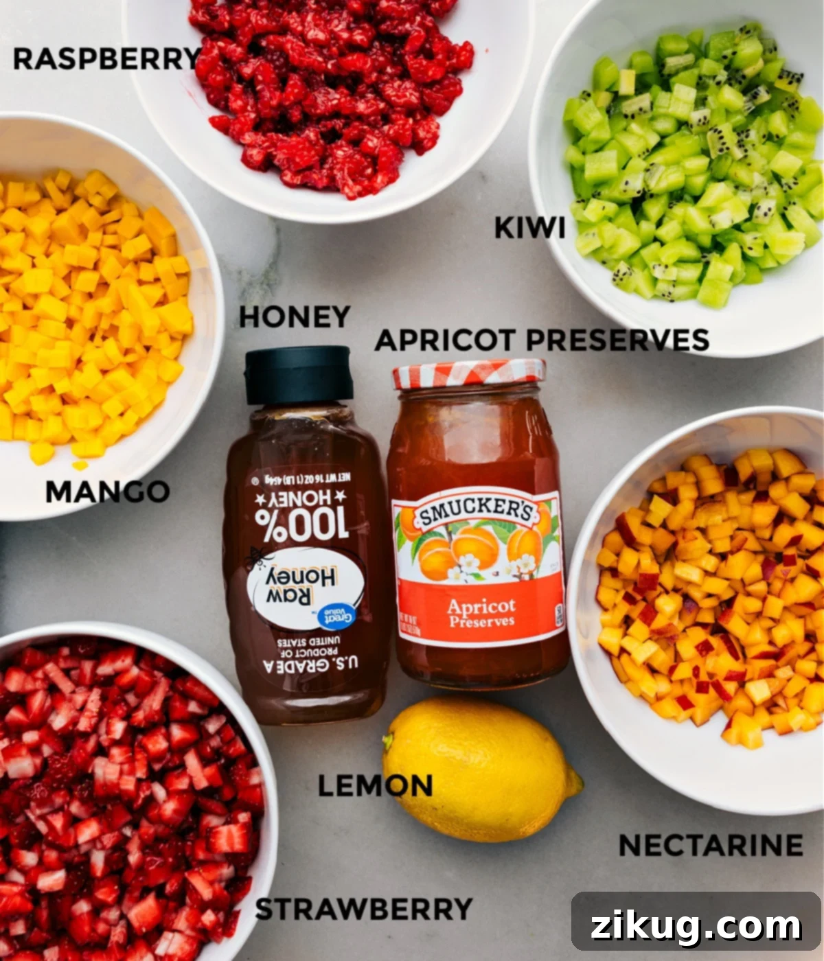 All the fresh fruit ingredients for fruit salsa prepped in separate bowls.