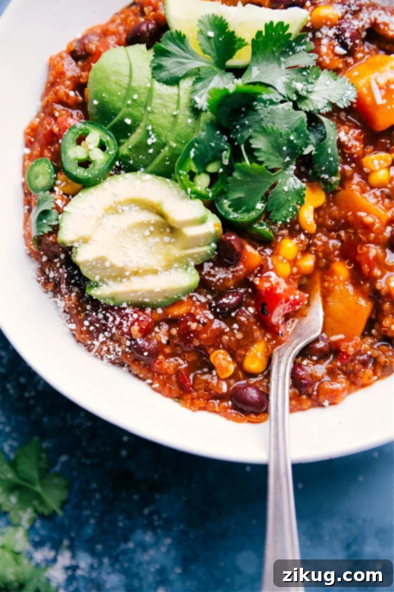 A serving of warm, freshly made Slow Cooker Mexican Quinoa, topped with cheese and cilantro, ready to be enjoyed.