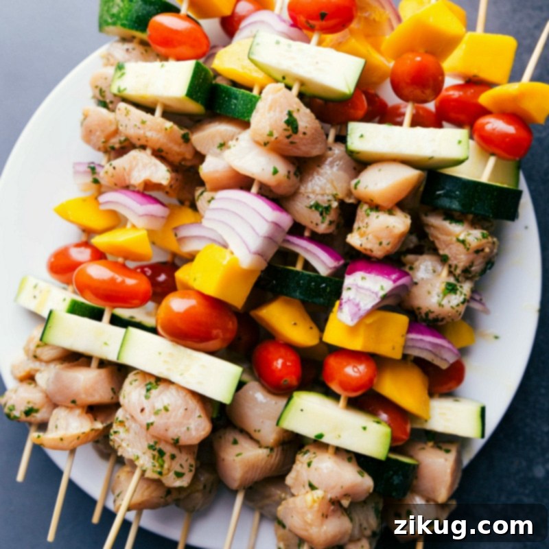 Preparing Chicken Kabobs for Grilling Uncooked chicken kabobs recipe, prepared and ready for grilling.