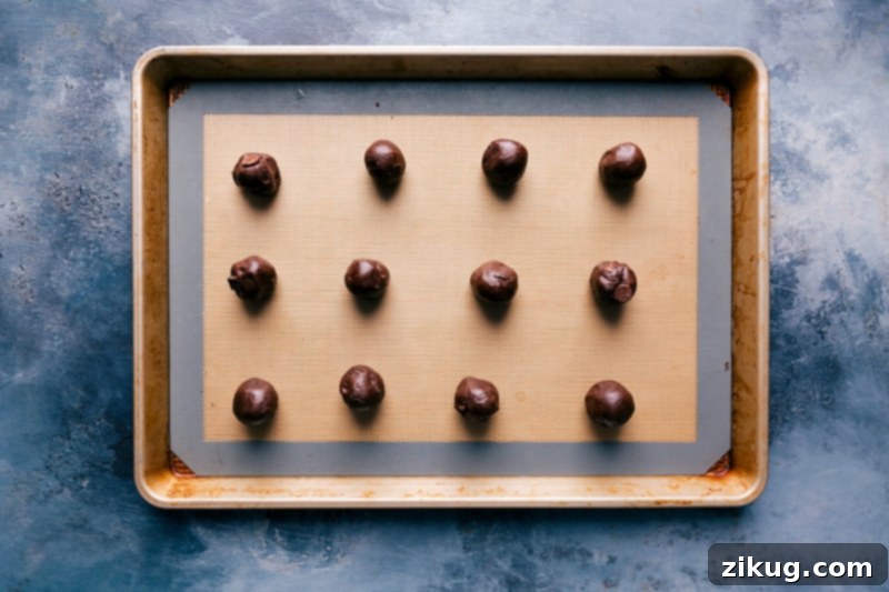 Prepared Cookie Dough Balls Uniformly rolled cookie dough balls for the fudge brownie cookies, ready for baking.