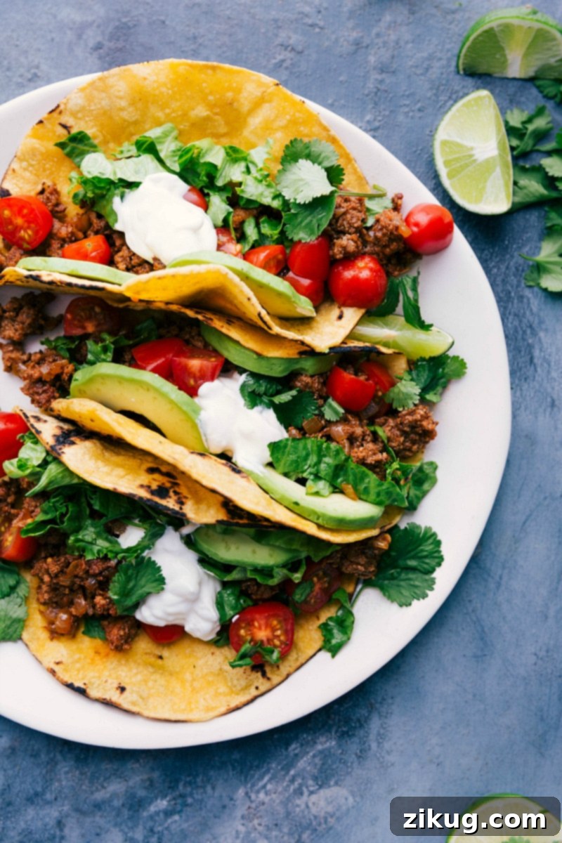 Delicious Turkey Tacos with Fresh Toppings and Bright Lime Wedges, Ready for Enjoyment Tantalizing turkey tacos on a plate, adorned with a vibrant array of toppings and accompanied by fresh lime wedges, eagerly awaiting to be savored.