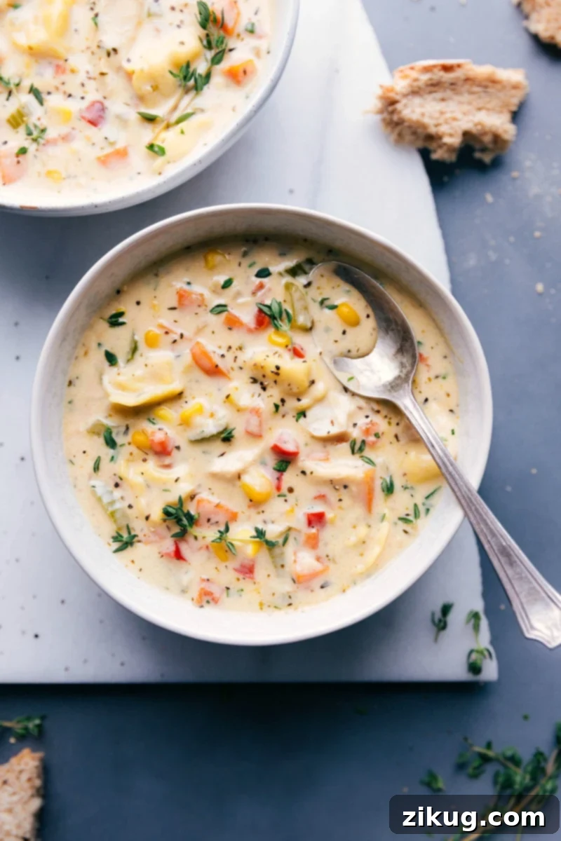 Velvety Chicken Tortellini Comfort Bowl 2 A steaming bowl of creamy chicken tortellini soup, garnished with fresh herbs, ready to be enjoyed with a side of crusty bread. Healthy, flavor-packed, and comforting.