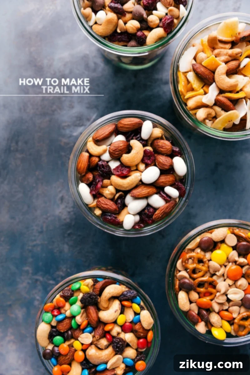 Assortment of five different types of delicious trail mix in clear glass jars, neatly arranged.