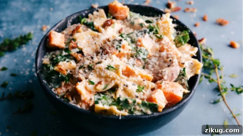 An indulgent Sweet Potato Pasta! The pasta and veggies are tossed in an unforgettable creamy goat cheese sauce and topped with Parmesan. Recipe via ChelseasMessyApron #dinner #quick #easy #simple #best #bowtie #sausage #sweetpotato #pasta Image of Sweet Potato Pasta in a bowl