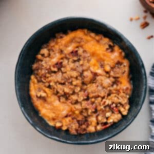 Slow Cooker Sweet Potato Delight 2 Crockpot Sweet Potato Casserole, a delicious slow cooker side dish with a pecan topping.