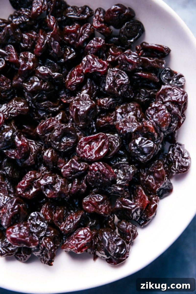 Close-up overhead view of vibrant ruby red dried tart cherries, highlighting their texture and color.