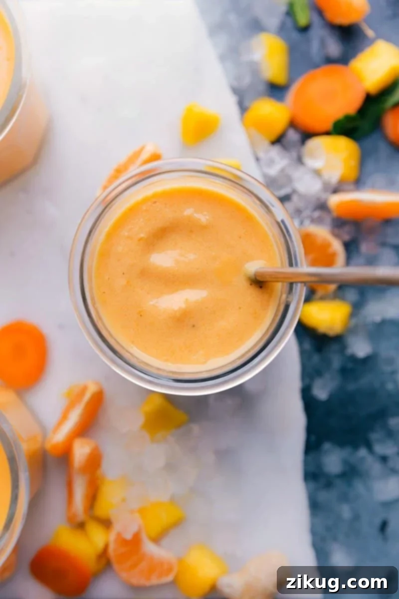 Nutrient-Rich Immune-Boosting Smoothies Immune boosting Smoothie surrounded by vibrant sliced fruit, a nutritious and colorful ensemble.