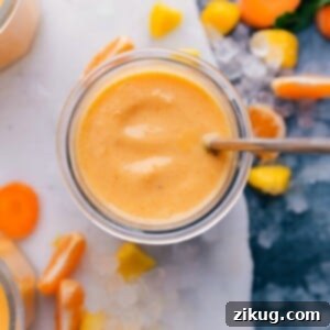 Immune boosting Smoothie surrounded by vibrant sliced fruit, a nutritious and colorful ensemble.