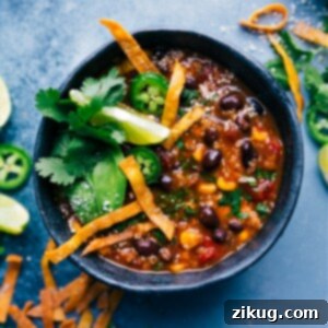 Close-up of a hearty bowl of Healthy Chicken Tortilla Soup with vibrant toppings