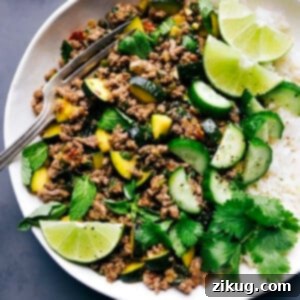 Zesty Thai Beef Larb 2 Beef larb accompanied by rice, with lime and cilantro garnishes.