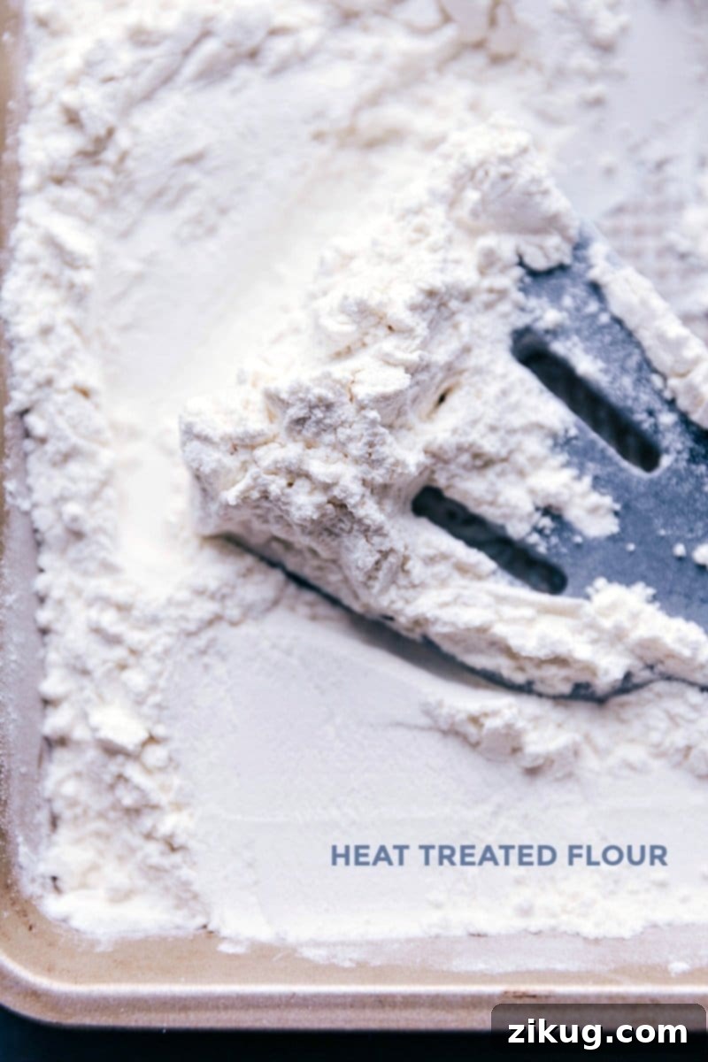 Making Flour Safe for No-Bake Recipes through Heat Treatment A practical image demonstrating how to heat-treat flour by spreading it thinly on a baking sheet, ensuring it's safe for use in no-bake recipes.