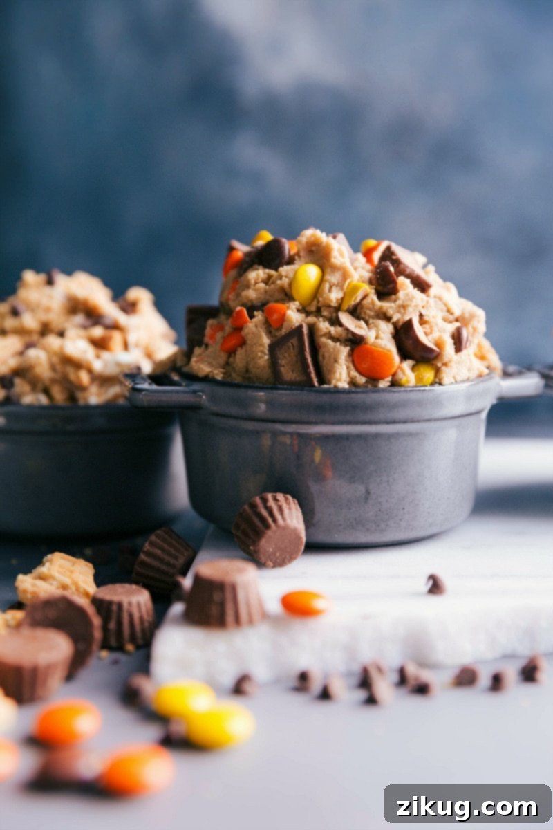 Delicious Reese's Peanut Butter Cookie Dough, Ready to Indulge A large, inviting bowl filled with ready-to-eat Reese's peanut butter cookie dough, generously garnished with extra Reese's pieces, highlighting its rich, creamy, and irresistible texture.