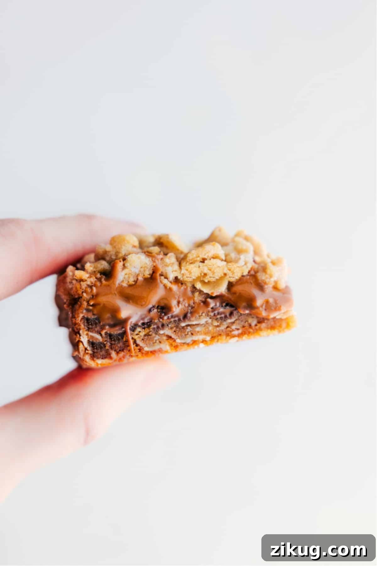 The Very Best Cookie Butter Bars A cookie butter bar being held up showing the gooey and delicious center.