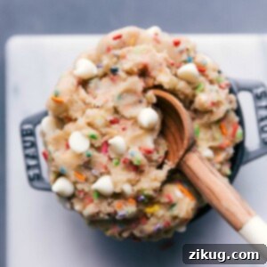 Scrumptious edible cake batter in a bowl, complete with a spoon, ready for indulgence.