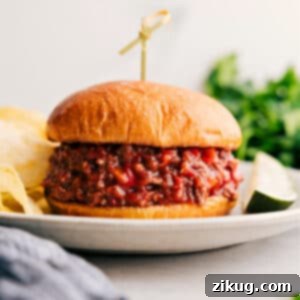 A delicious Sloppy Joe sandwich, bursting with savory meat filling, served on a toasted bun.