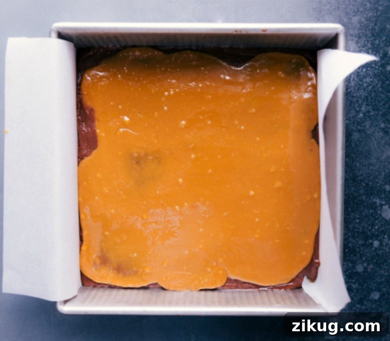 Our Favorite Microwave Fudge with Caramel A freshly made pan of Microwave Fudge with a smooth, golden caramel layer spread perfectly on top, ready for chilling.