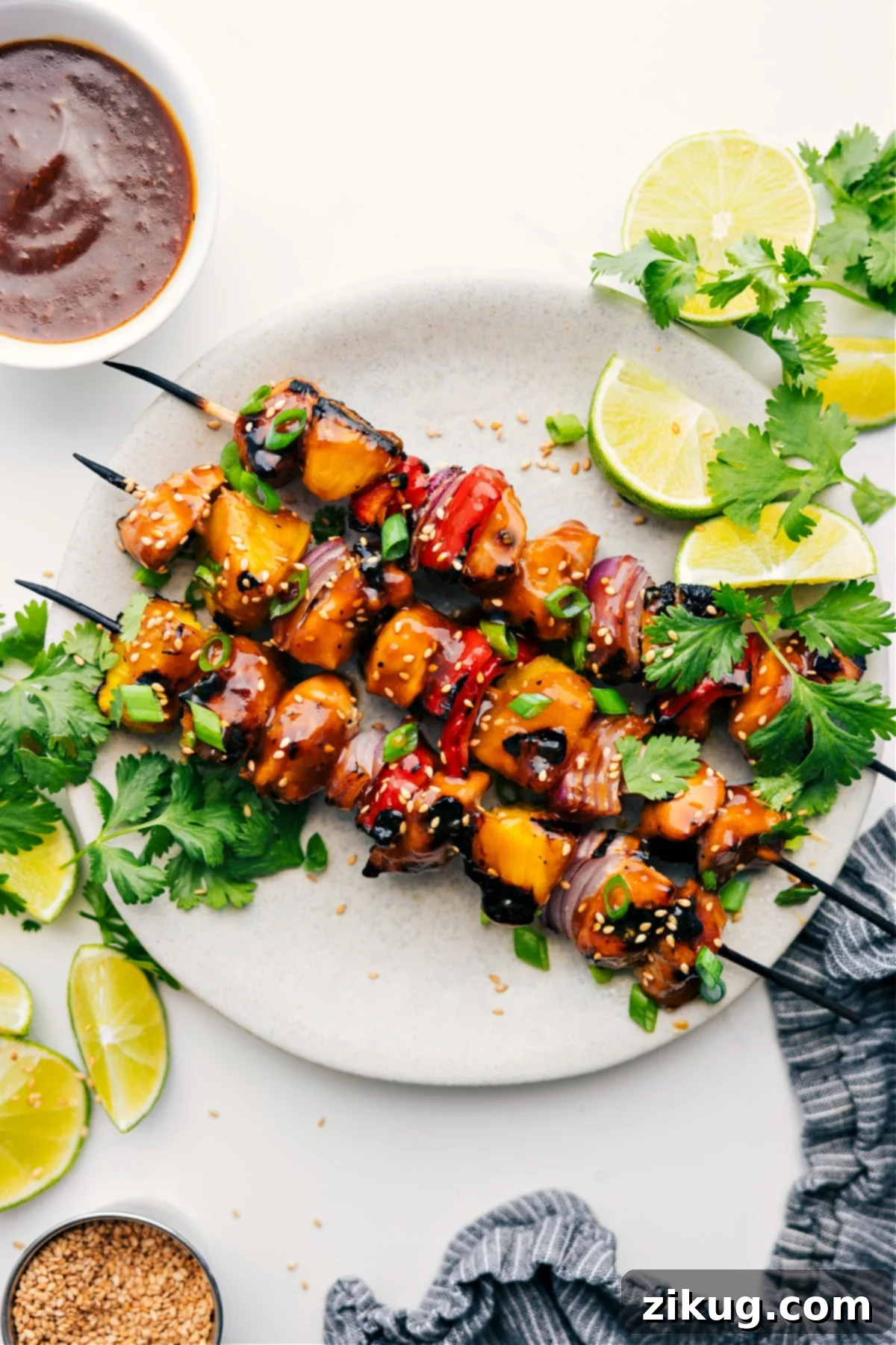 Teriyaki Chicken Skewers Are The Best Summer Dinner Teriyaki Chicken Skewers served with lime wedges, cilantro, and dipping sauce, highlighting their vibrant colors and juicy texture.