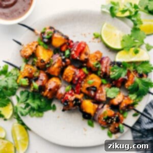Grilled Teriyaki Chicken Skewers with pineapple and vegetables, served with fresh lime.