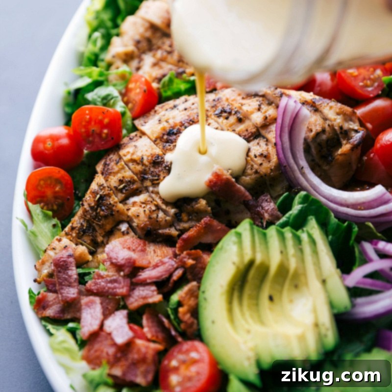 Flavorful Addition: Drizzling Honey Mustard Dressing on Grilled Chicken Finished homemade sauce being poured over grilled chicken, enhancing the dish with delightful flavor.