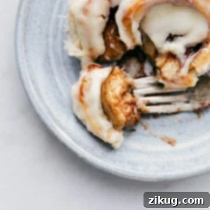 Melt-in-Your-Mouth Cinnamon Rolls 2 Homemade Cinnamon Roll with a bite taken out of it, showing the soft interior and frosting.