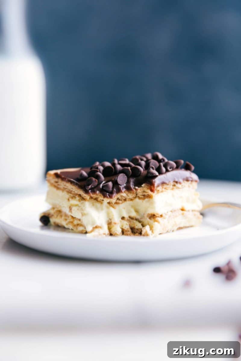 A delicious slice of eclair cake with a bite taken out, revealing its creamy center.