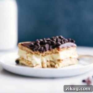 A delicious slice of eclair cake with a bite taken out, revealing its creamy center.