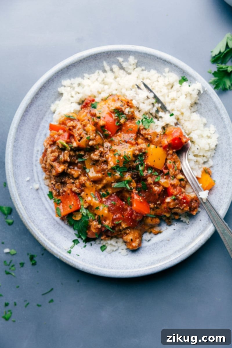 Delicious Unstuffed Peppers with Cauliflower Rice - A Wholesome Meal A perfectly plated serving of delicious and savory unstuffed bell peppers, garnished with fresh herbs, and accompanied by a side of fluffy cauliflower rice, ready to be enjoyed.