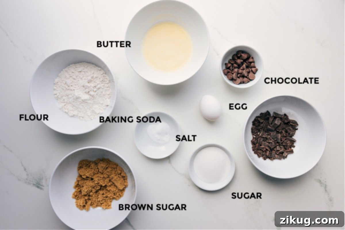 All ingredients laid out and prepped for easy assembly: butter, flour, baking soda, chocolate, egg, sugar, and brown sugar.