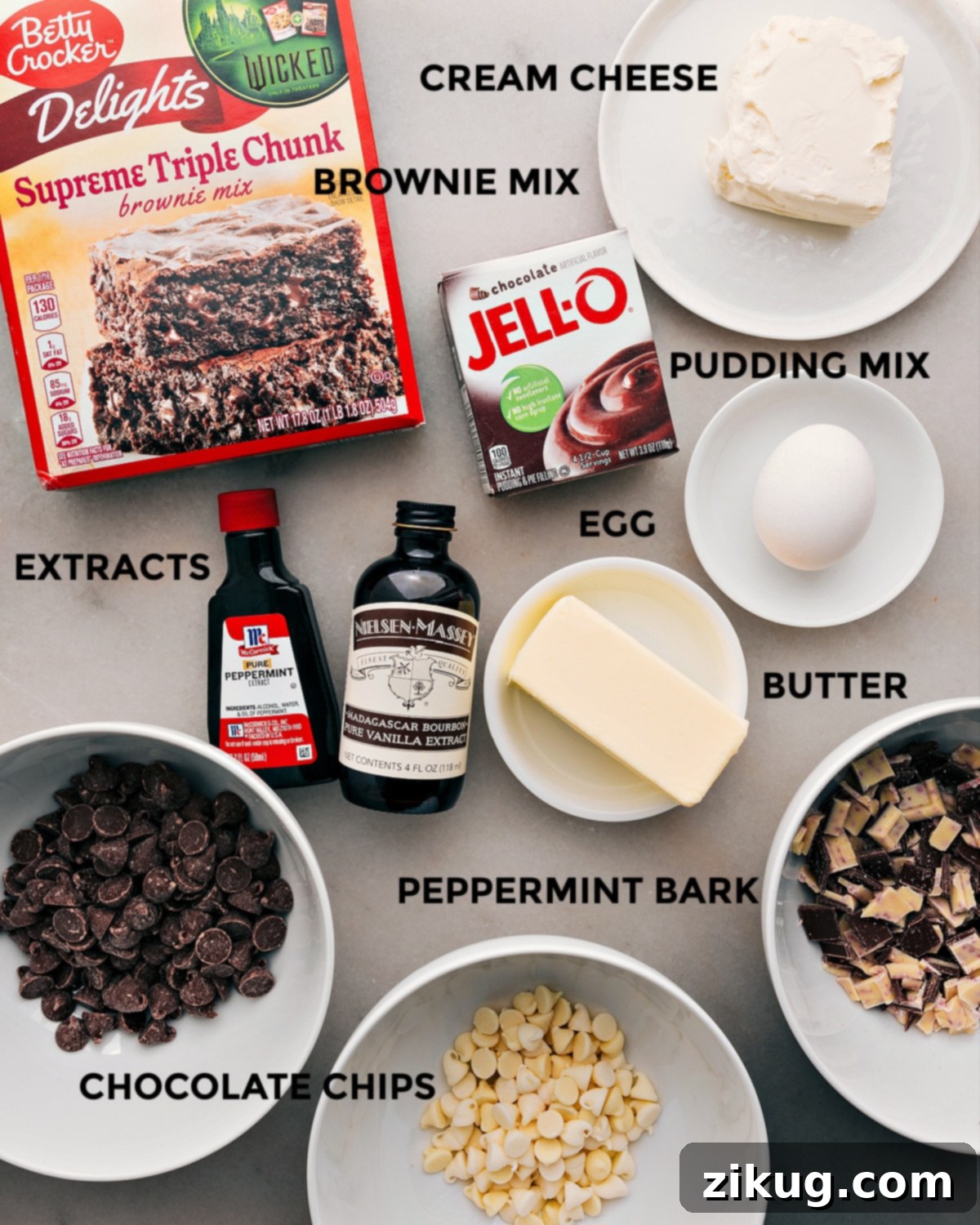 Gathering Your Ingredients for Perfect Chocolate Peppermint Cookies All the essential ingredients for making these delightful chocolate peppermint cookies are neatly arranged, including brownie mix, pudding mix, cream cheese, egg, butter, extracts, and an assortment of chocolate chips, ready for mixing.
