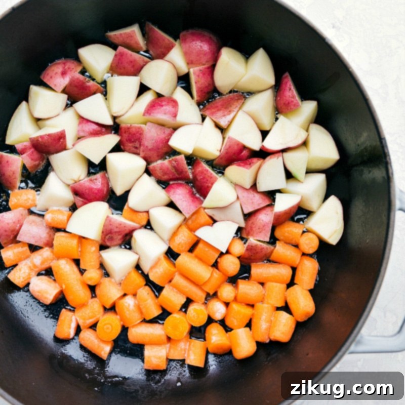 A healthy, fresh, and flavorful one skillet meal - Lemon Chicken, Red Potatoes, and Carrots. Potatoes and carrots in a skillet