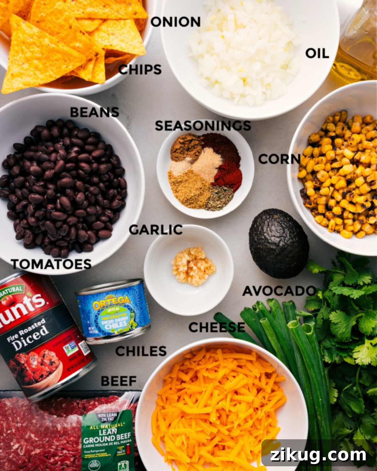 Ingredients In Taco Skillet Recipe All the essential ingredients for an easy taco skillet recipe are prepped and laid out: a selection of vibrant seasonings, lean ground meat, sweet corn, creamy avocado, aromatic garlic, diced tomatoes, mild green chiles, shredded cheese, crunchy tortilla chips, and fresh herbs.