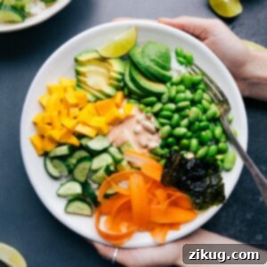 Vegetarian sushi bowl with all the ingredients arranged together and the sauce in the middle.