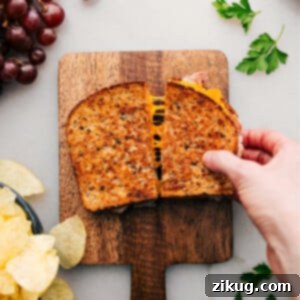 A perfectly grilled ham and cheese sandwich, golden brown and melty.