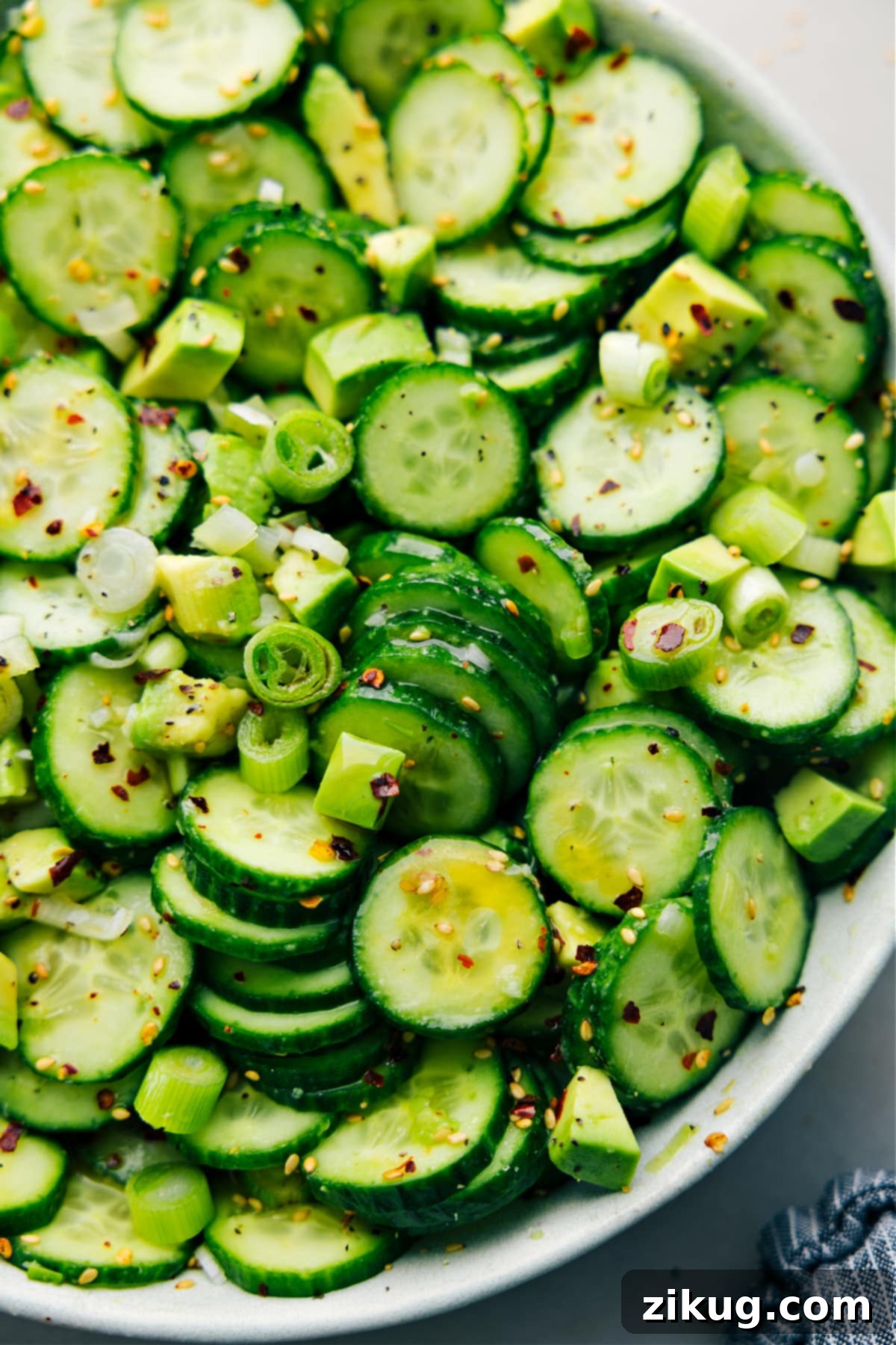 Asian Cucumber Salad in a bowl dressed and tossed together for a light side dish.