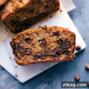 A freshly baked slice of Nutella Banana Bread with chocolate chips.