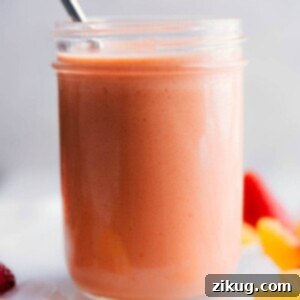 A glass of creamy peach smoothie.