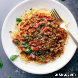 Hearty Turkey Bolognese 2 Savory and delicious turkey bolognese on a bed of spaghetti, topped with fresh herbs.