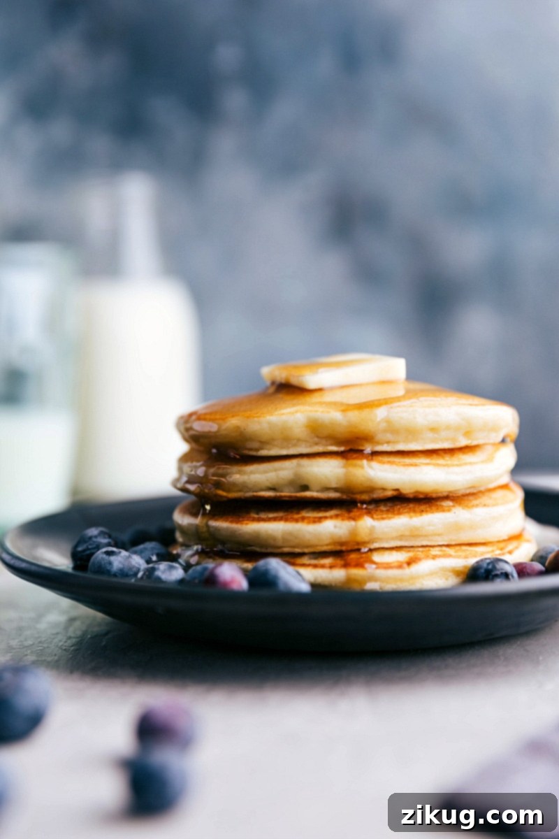 Enjoy a stack of healthy, protein-packed pancakes! A beautifully arranged stack of golden-brown Greek Yogurt Pancakes, ready for breakfast or brunch.