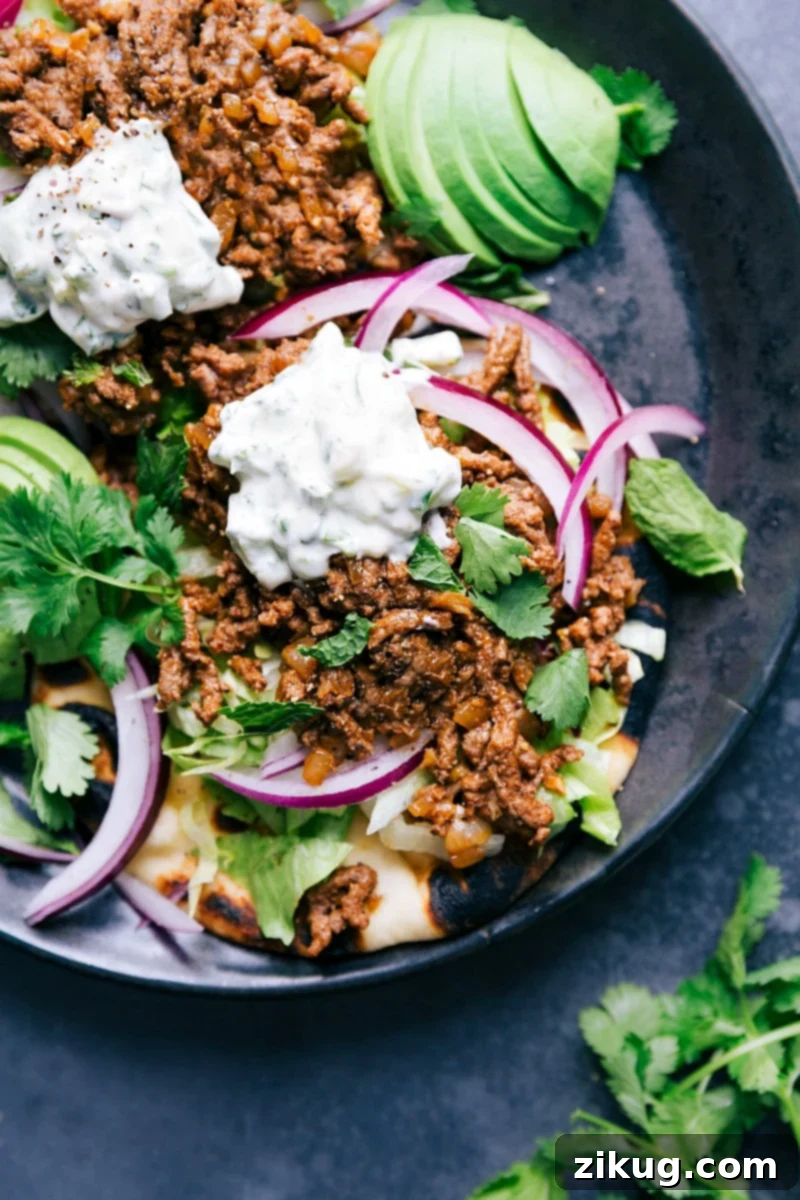 Ground Beef Naan Tacos - Flavorful and Satisfying Weeknight Dinner Delicious Ground Beef Naan Tacos with fresh toppings and a creamy sauce, showcasing a quick and flavorful meal perfect for any day.