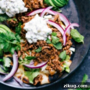 Fusion Beef Naan Tacos 2 Ground beef naan tacos with all the toppings, a delicious meal with complimentary flavors ready to be enjoyed.