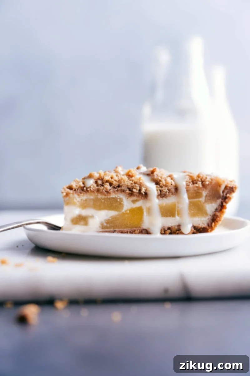 A beautifully baked Apple Streusel Pie, featuring a golden streusel topping and a rich pecan crust, perfect for any holiday celebration.
