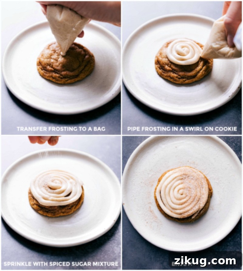 A skilled hand piping a generous swirl of creamy white frosting onto a freshly baked pumpkin cinnamon roll cookie, with a sprinkle of spiced sugar mixture already adorning its surface, highlighting the final decorative touch before enjoyment.