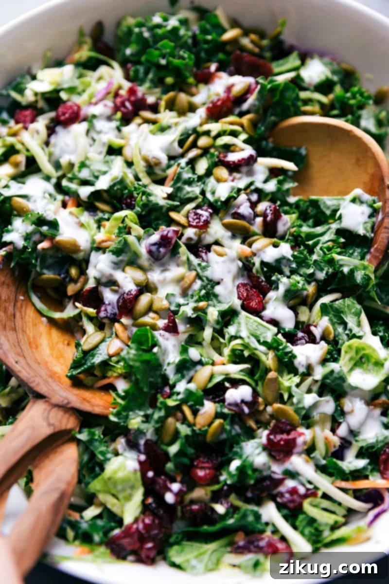 A serving of Costco Kale Salad in a glass bowl, garnished with extra pepitas, ready to be enjoyed.